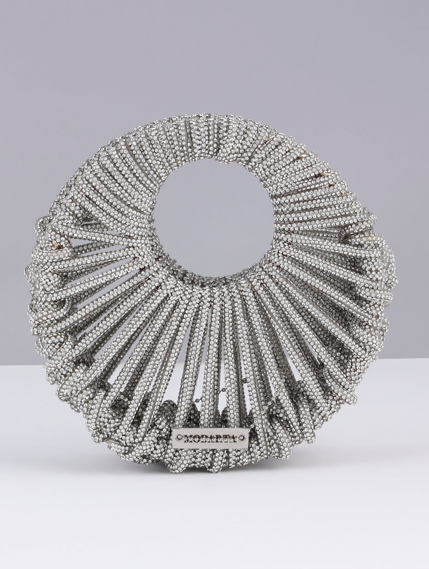 KRITIKA KHURANA THE BOHO GIRL CARRYING MODARTA SILVER CRESCENT CLUTCH