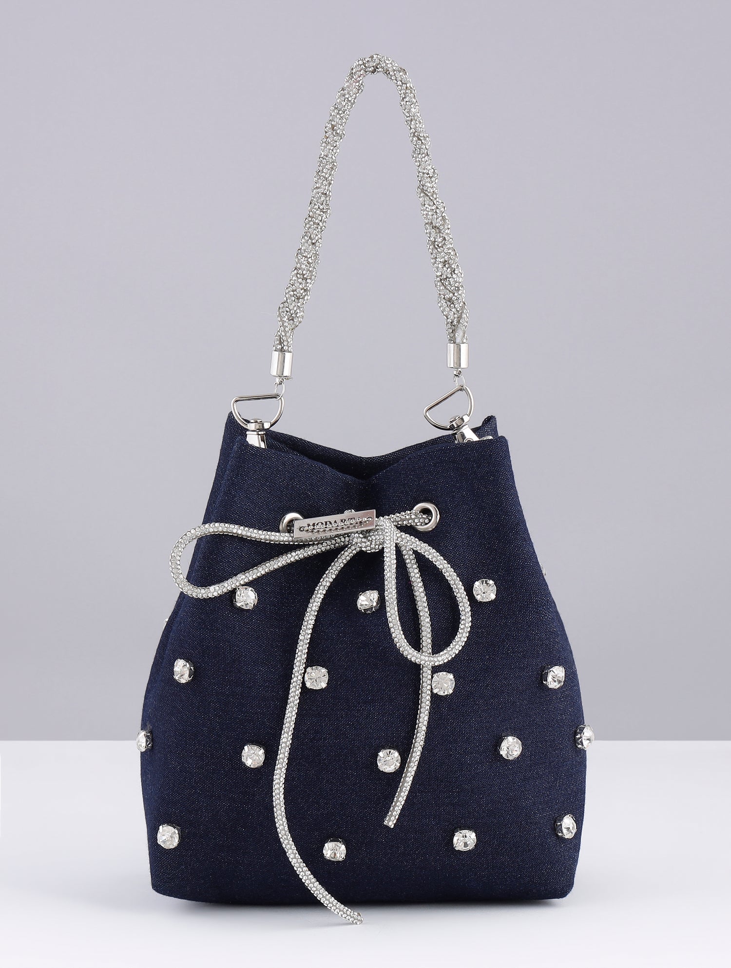 Denim bucket bag placed on neutral fashion background