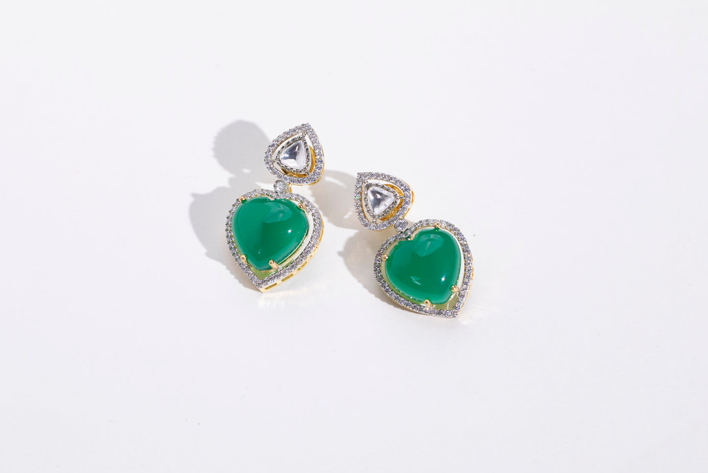Stylish Heart Shaped Swarovski Earrings: Elevate your style with these trendy earrings for women." "Statement Piece: Heart Shaped Emerald and Swarovski Earrings: Make a fashion statement with these stylish earrings." "Versatile Heart Shaped Earrings: Perfect for any outfit, these earrings are a must-have for every fashionista." "Fashionable Heart Shaped Emerald Earrings: Complete your look with these trendy earrings, perfect for all occasions
