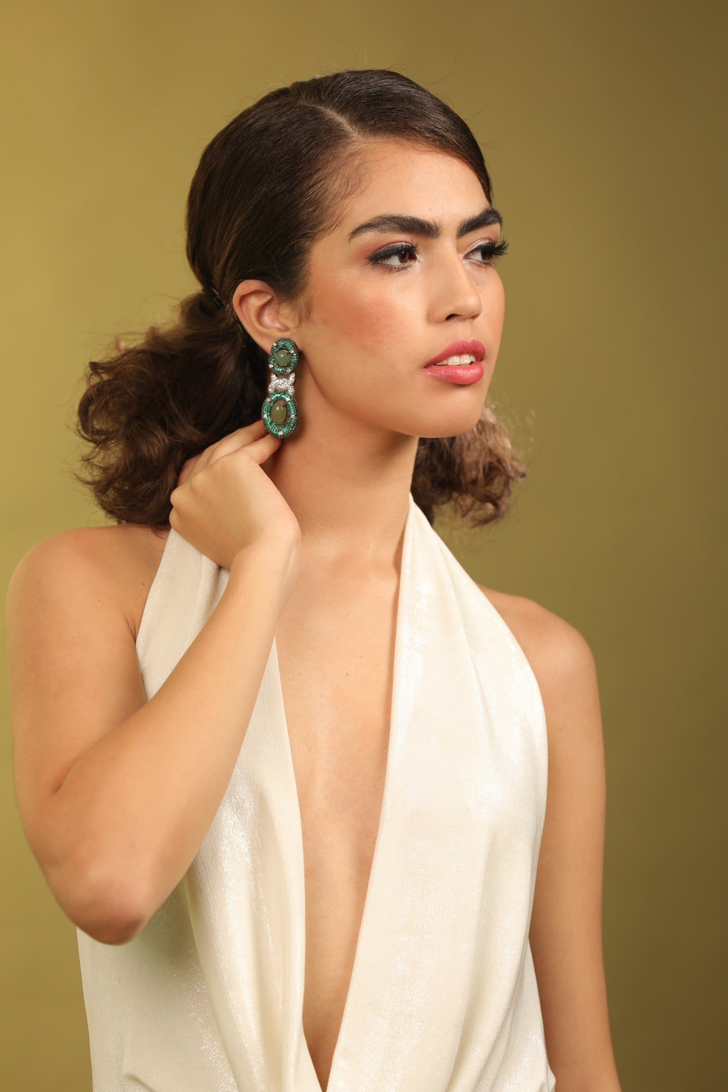 Quintessential Statement Earrings: Entangled chain dangler earrings with emerald and Swarovski crystals." "Stand Out with Style: Make a statement with our unique entangled chain dangler earrings