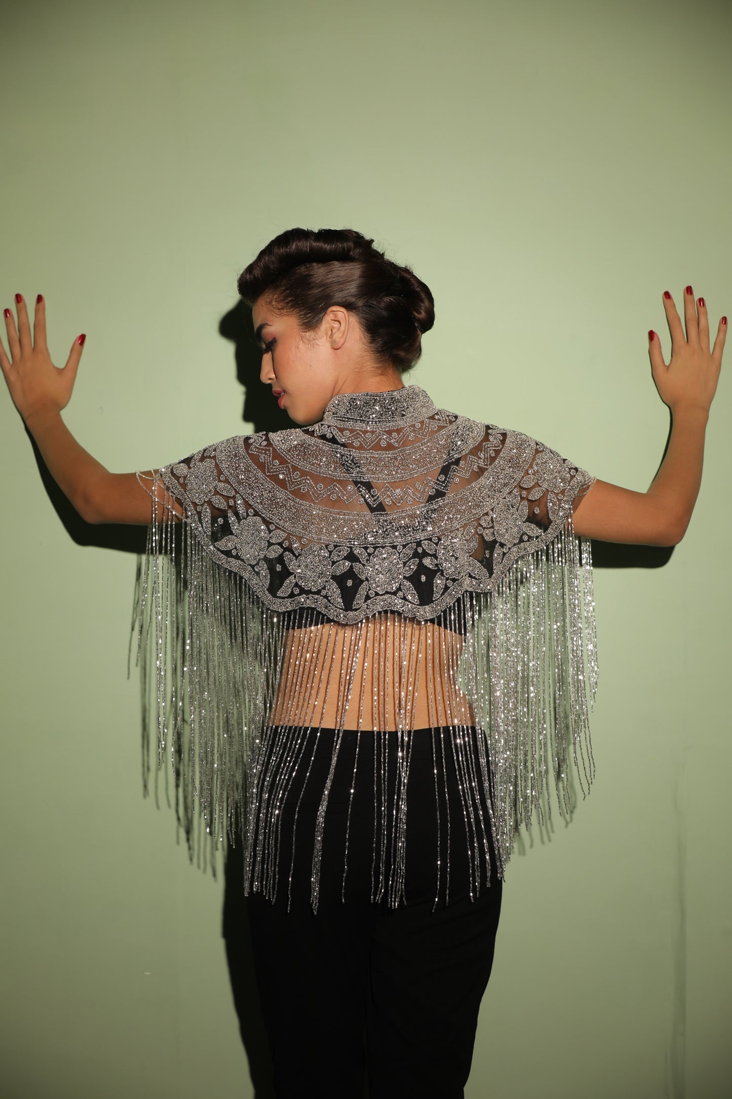 Elevate your saree or gown ensemble with our handcrafted silver beaded cape, featuring intricate embroidery and stylish tassels. This unique cape is meticulously crafted to add a touch of elegance and glamour to your outfit.