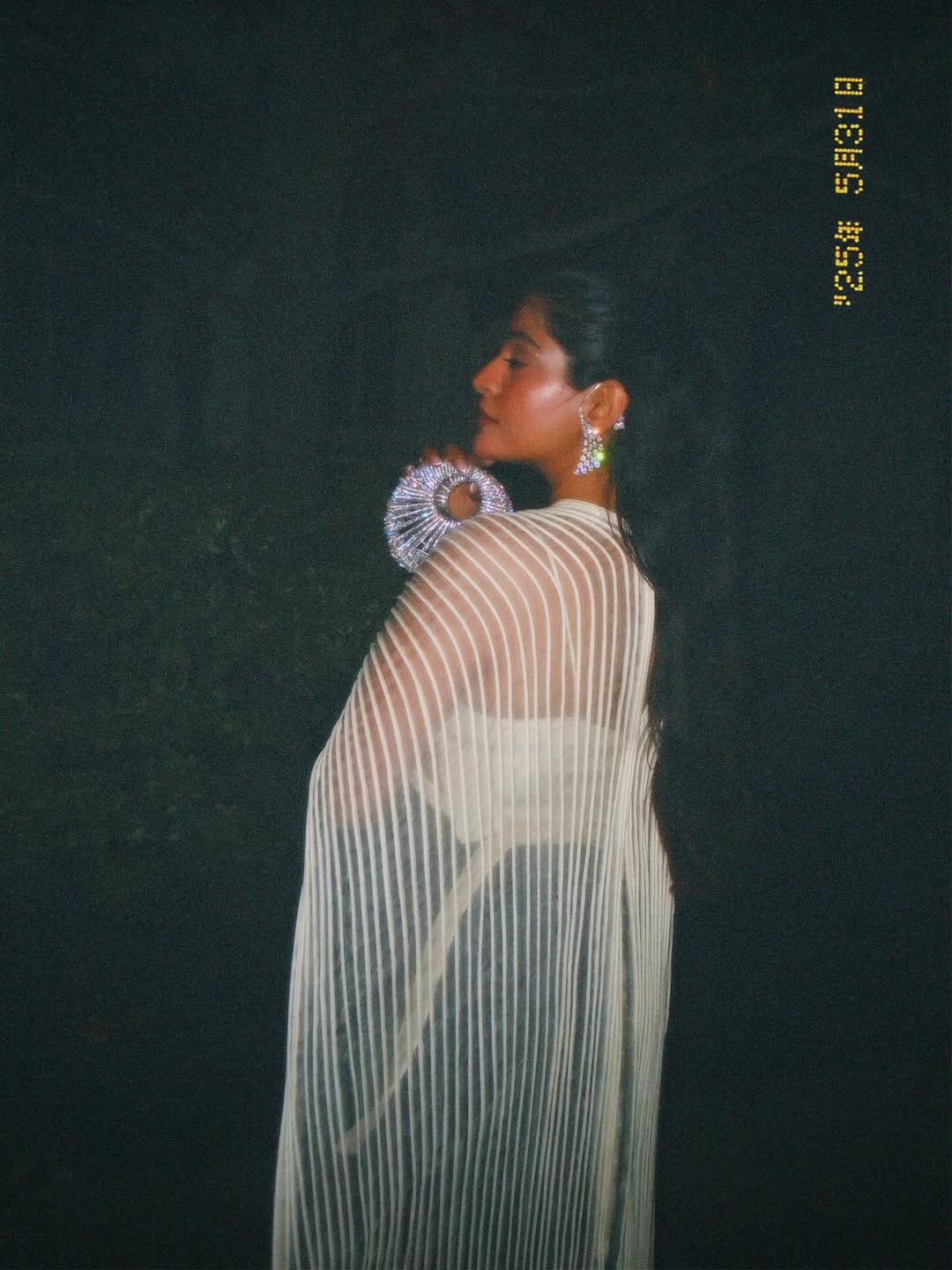 Boho Girl carrying silver crescent bag at Tudum