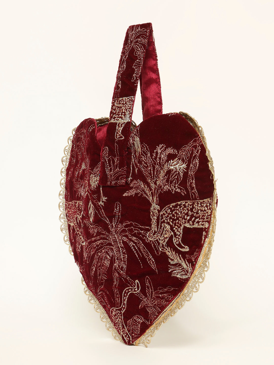 Close-up of bird embroidery on red velvet potli