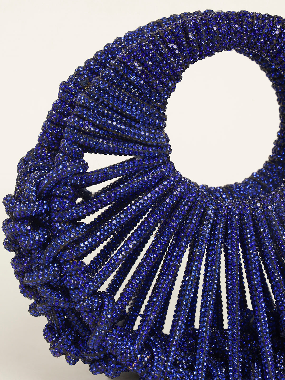 Close-up of blue crystal moon-shaped evening clutch