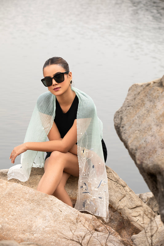  Elevate your style with our exquisite white silk scarf, perfect for women seeking elegance and versatility. This lightweight cotton scarf doubles as a chic headscarf, offering sophistication and comfort for any occasion.