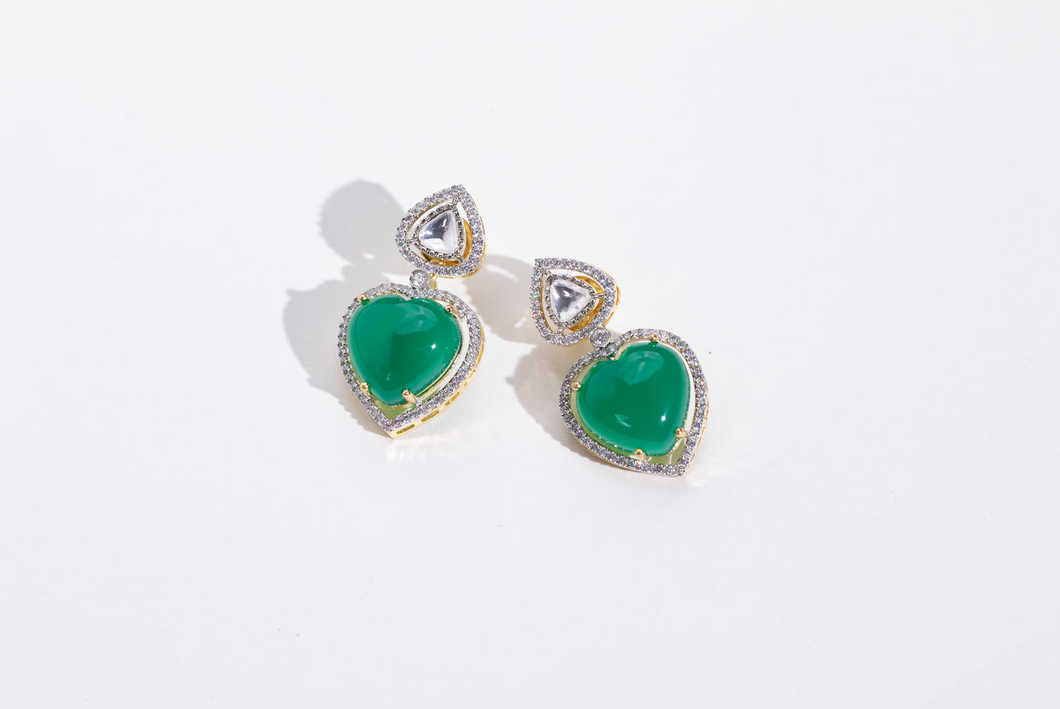 Stylish Heart Shaped Swarovski Earrings: Elevate your style with these trendy earrings for women." "Statement Piece: Heart Shaped Emerald and Swarovski Earrings: Make a fashion statement with these stylish earrings." "Versatile Heart Shaped Earrings: Perfect for any outfit, these earrings are a must-have for every fashionista." "Fashionable Heart Shaped Emerald Earrings: Complete your look with these trendy earrings, perfect for all occasions