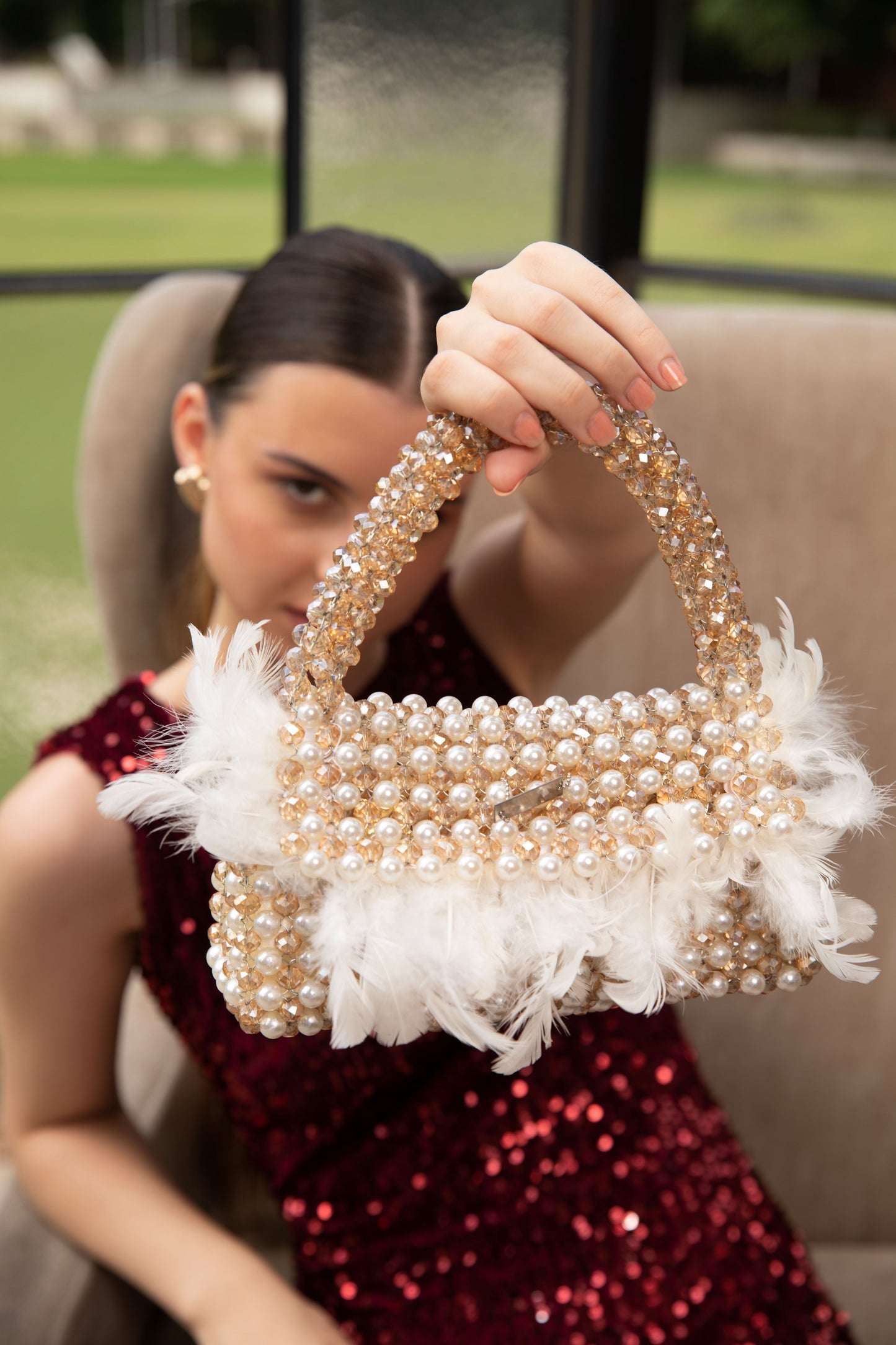 Pearl beaded bag decorated with feathers