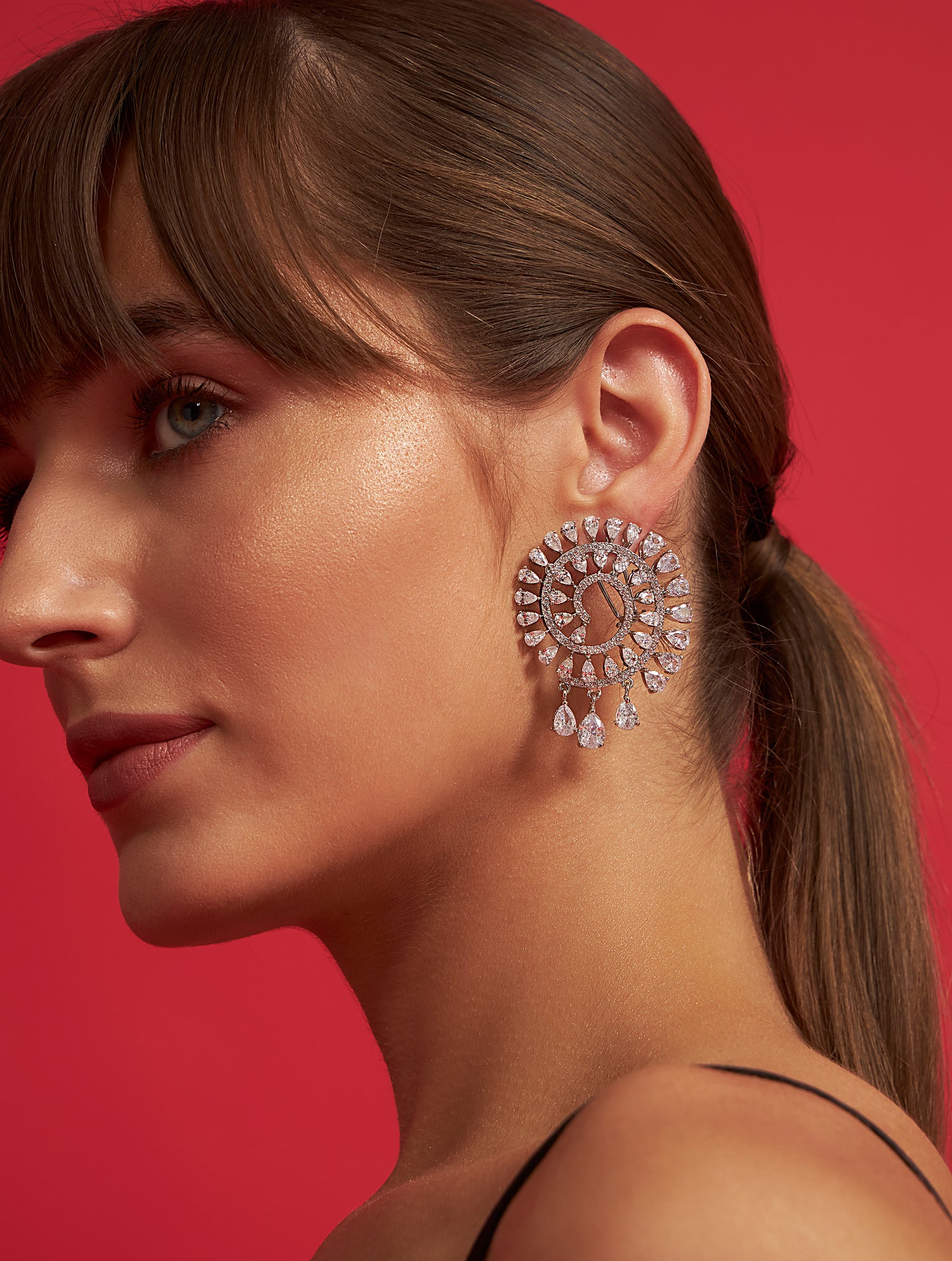 Designer spiral solitaire silver crystal earrings with statement styling