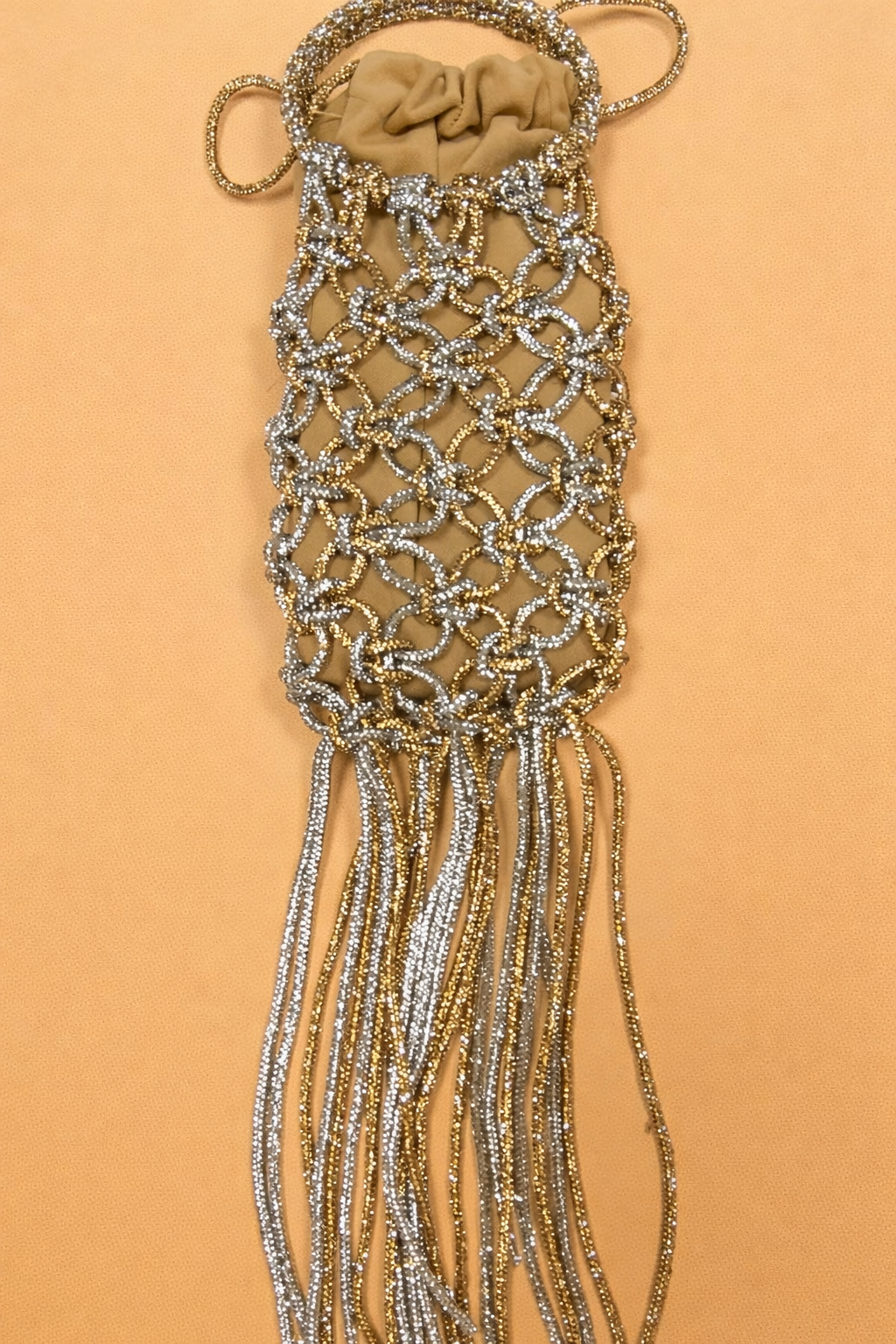 Close-up of dual tone crystal knot and fringe bag