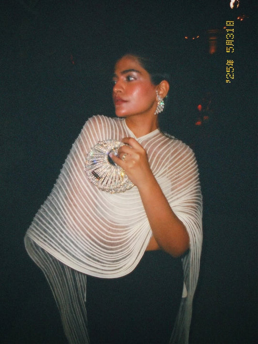 Kritika Khurana holding silver Modarta crescent clutch bag