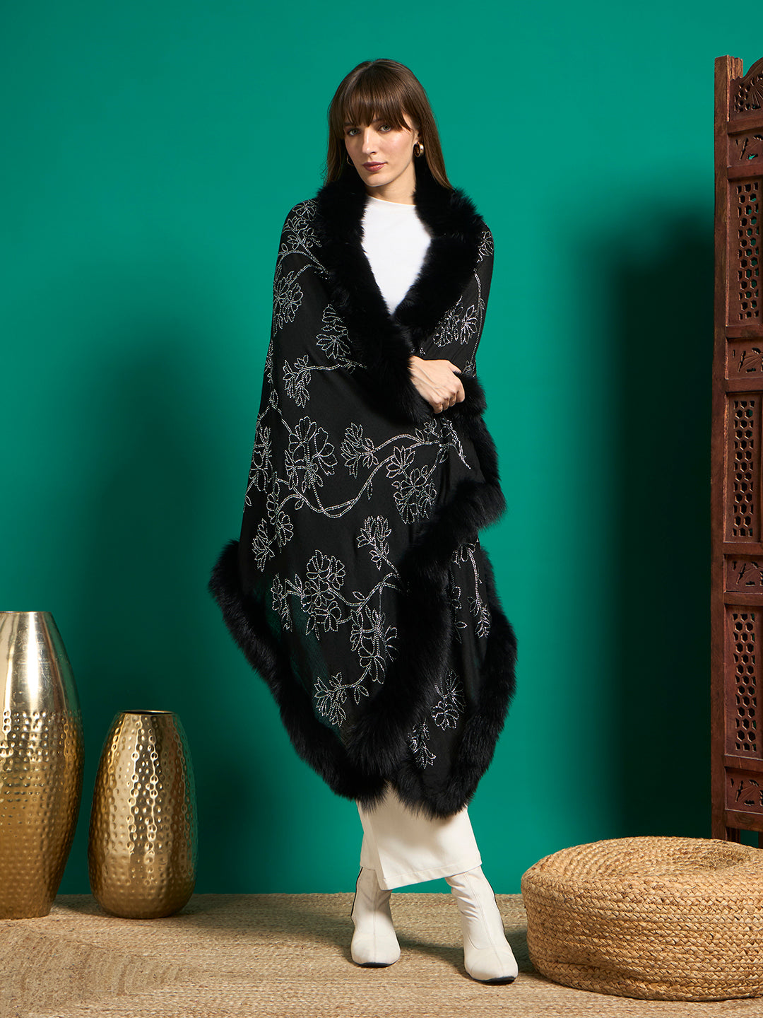 Model wearing black shawl with silver crystal floral vines and black faux fur trim, wrapped over shoulders