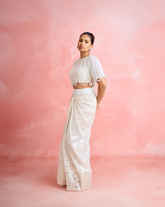 Aashna Hegde wearing Modarta emerald and pearl cluster stud earrings with a pearl-draped top and ivory draped skirt