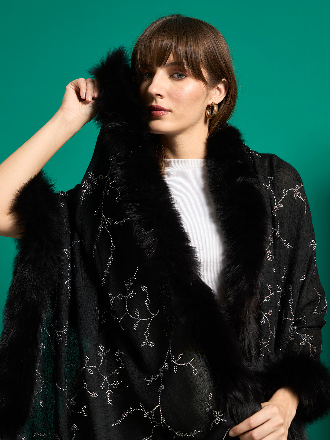 Close-up of black shawl with plush faux fur collar trim and silver crystal vine pattern