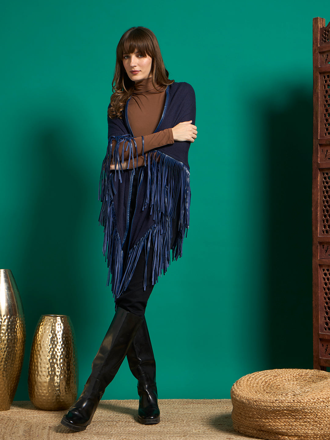 Model wrapped in navy triangular shawl with long royal blue fringe edging, arms crossed