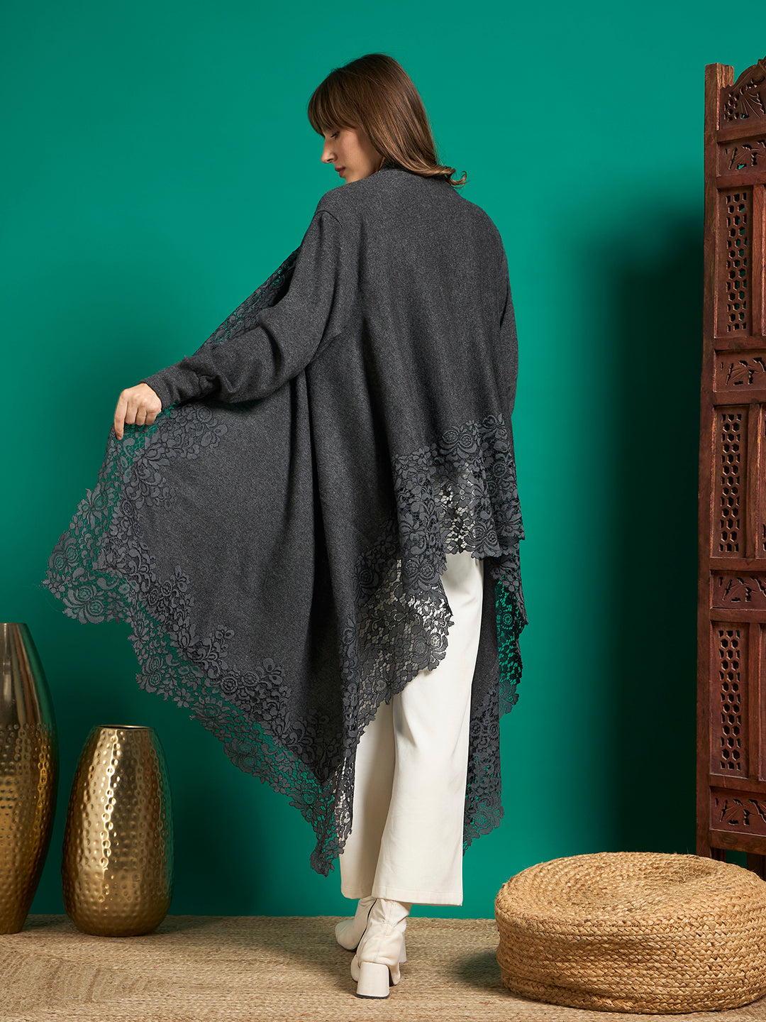 Back view of grey cape showing plain back panel and floral lace along the asymmetric hem