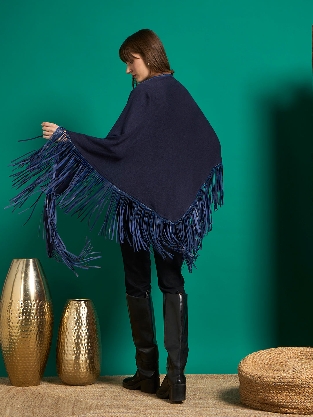 Back view of navy triangular shawl with V-shaped point and royal blue fringe along the edges