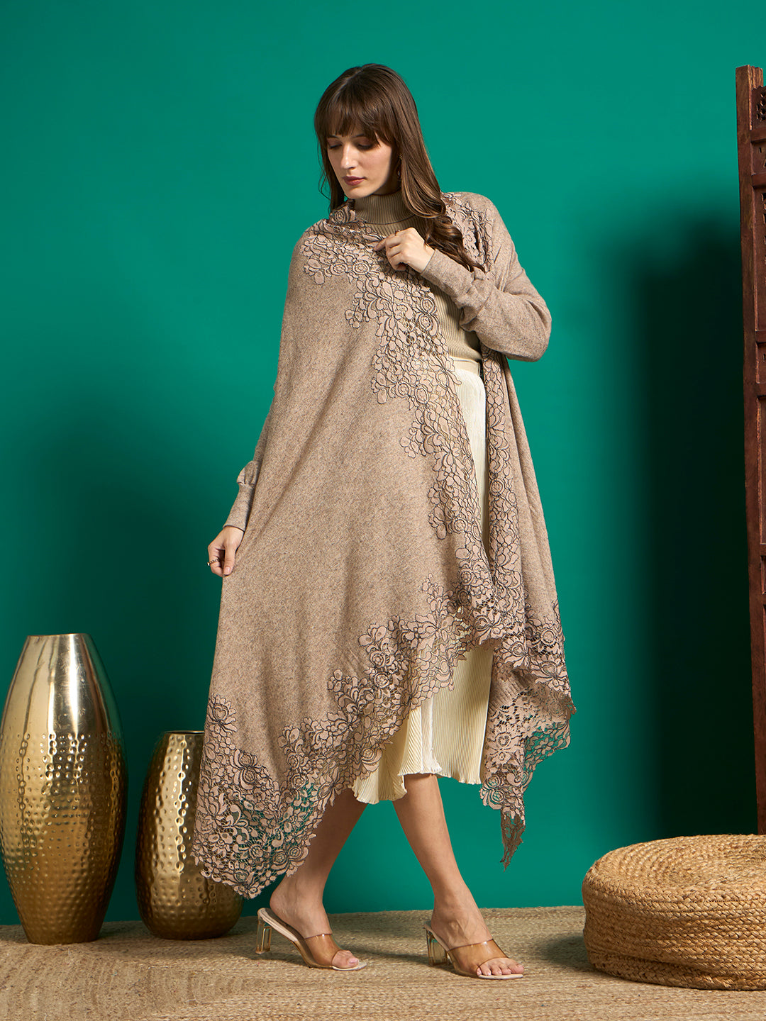Taupe knit cape draped across the body, showing the scalloped floral lace border and pointed handkerchief hem