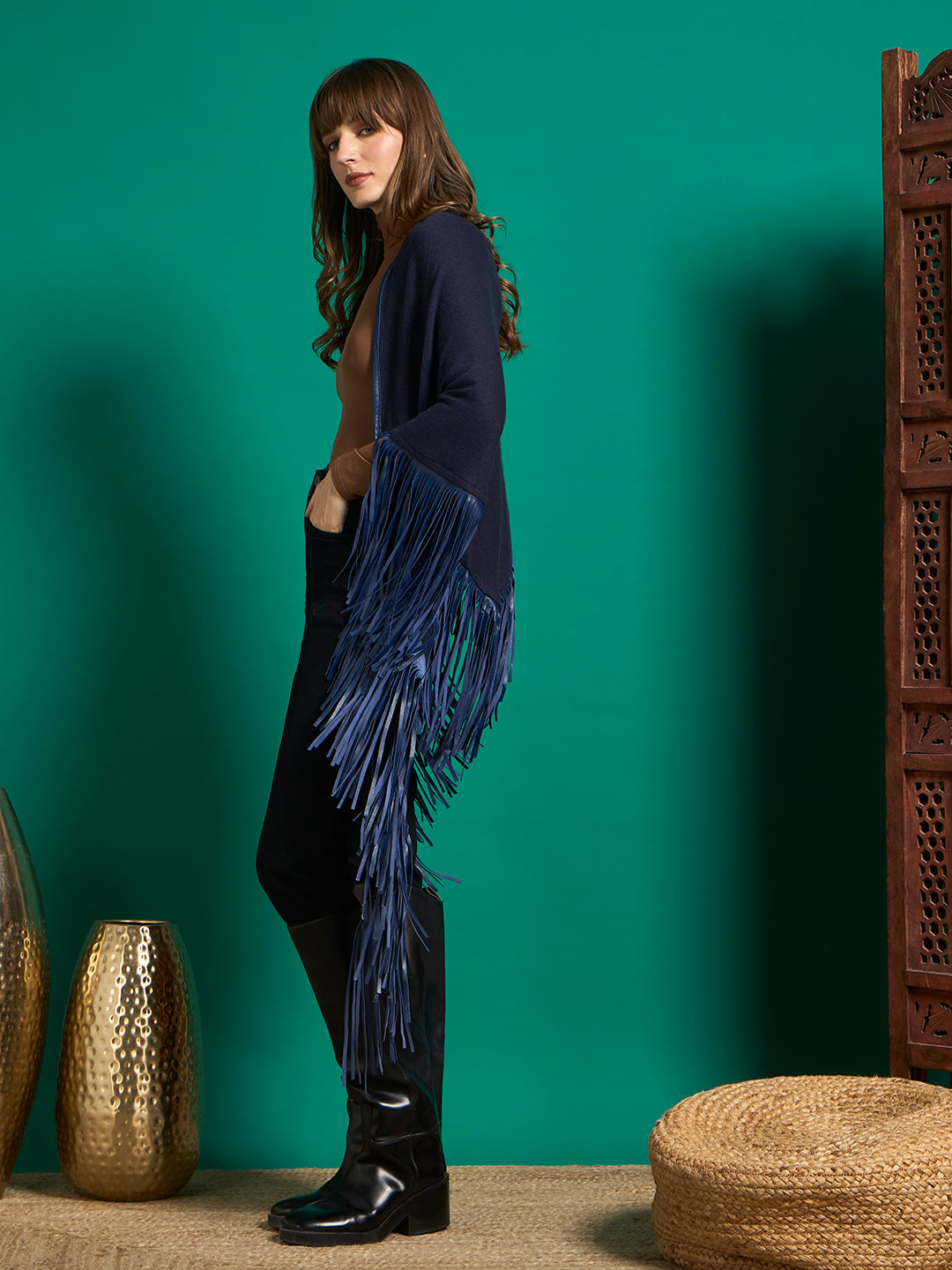 Side view of navy shawl showing long blue fringe cascading from shoulder to calf