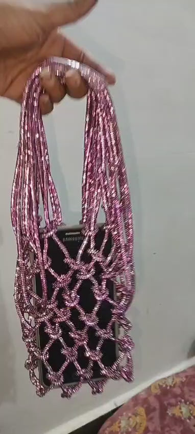 Sparkling pink beaded evening clutch on white background